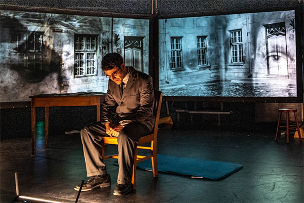 This one-man show incorporates screens projecting flashbacks and imagery.